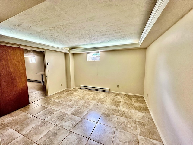 310 W Armitage St, Ennis, MT 59729 - below grade area featuring a baseboard heating unit, a textured ceiling, and baseboards