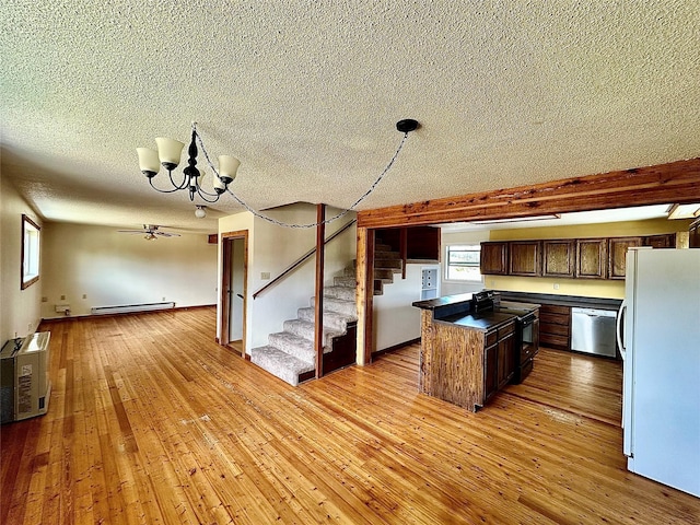 310 W Armitage St, Ennis, MT 59729 - kitchen featuring freestanding refrigerator, black electric range, dishwasher, baseboard heating, and dark countertops