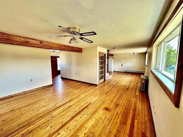 310 W Armitage St, Ennis, MT 59729 - empty room with a textured ceiling, baseboard heating, hardwood / wood-style flooring, ceiling fan, and baseboards