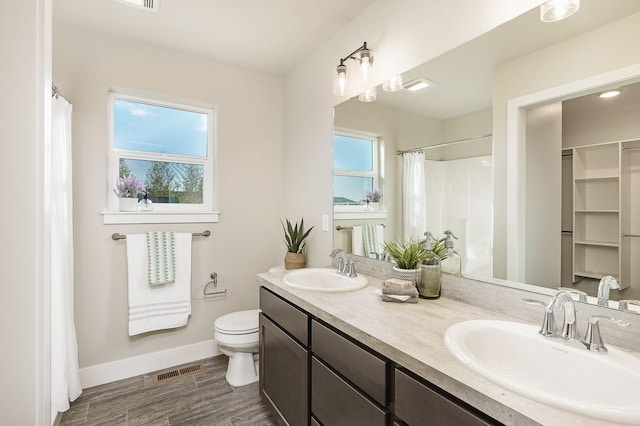 249 Stirling Loop, East Helena, MT 59635 - full bath with baseboards, toilet, wood finished floors, double vanity, and a shower with shower curtain