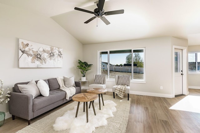 249 Stirling Loop, East Helena, MT 59635 - living area featuring wood finished floors, lofted ceiling, ceiling fan, and baseboards