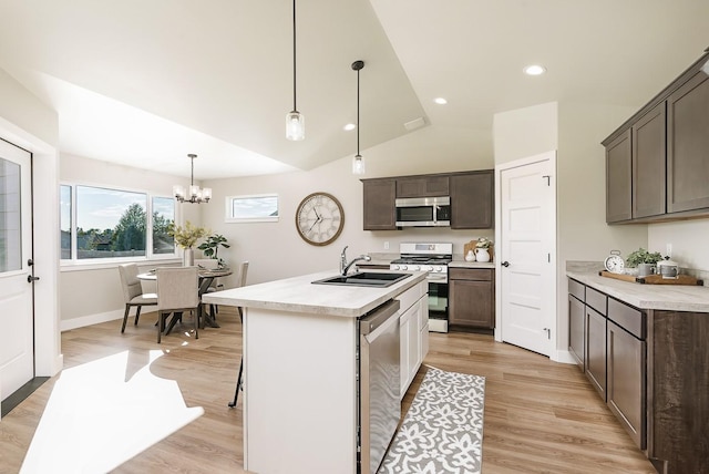249 Stirling Loop, East Helena, MT 59635 - kitchen featuring appliances with stainless steel finishes, a sink, light countertops, light wood-type flooring, and vaulted ceiling