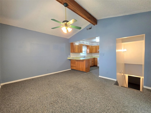 3421 4th Ave N, Great Falls, MT 59401 - kitchen with brown cabinets, a ceiling fan, light countertops, a peninsula, and dark carpet