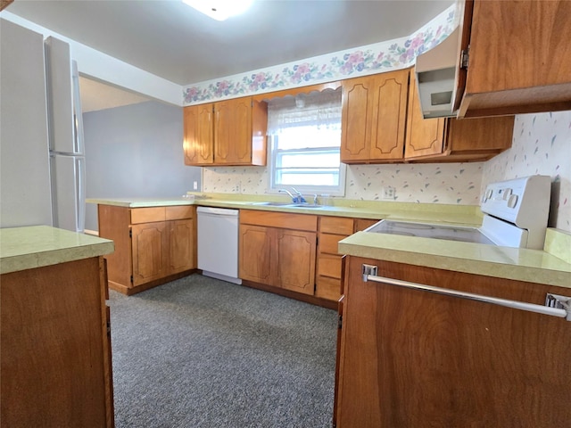 3421 4th Ave N, Great Falls, MT 59401 - kitchen with white appliances, a sink, brown cabinets, and light countertops