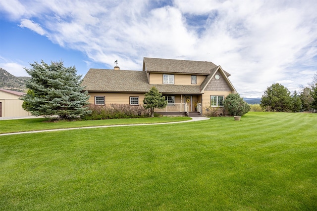150 Painted Mdws, Butte, MT 59701 - view of front of home featuring a front lawn, a chimney, covered porch, and a shingled roof