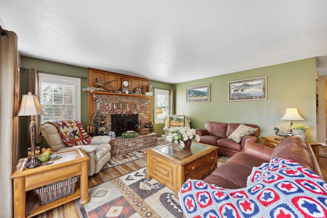 150 Painted Mdws, Butte, MT 59701 - living area with healthy amount of natural light, a brick fireplace, and wood finished floors