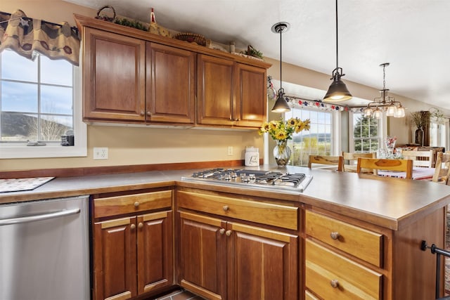 150 Painted Mdws, Butte, MT 59701 - kitchen with appliances with stainless steel finishes, brown cabinetry, pendant lighting, and a peninsula