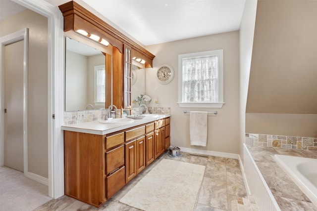 150 Painted Mdws, Butte, MT 59701 - full bathroom with double vanity, healthy amount of natural light, a relaxing tiled tub, and baseboards