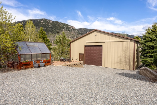 150 Painted Mdws, Butte, MT 59701 - detached garage featuring a mountain view and gravel driveway