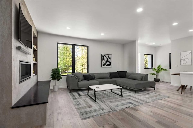 713 W 2nd St W, Whitefish, MT 59937 - living area with recessed lighting, plenty of natural light, wood finished floors, built in features, and baseboards