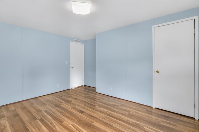 3805 7th St NE Unit 107, Great Falls, MT 59404 - unfurnished bedroom featuring wood finished floors