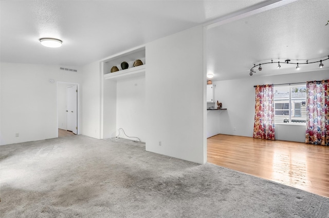 3805 7th St NE Unit 107, Great Falls, MT 59404 - unfurnished room featuring carpet and a textured ceiling
