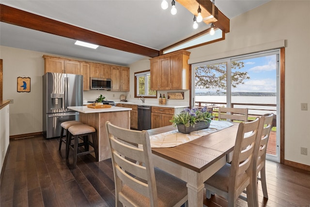 38941 Baypoint Ln, Polson, MT 59860 - dining area with a water view, baseboards, and dark wood-style floors