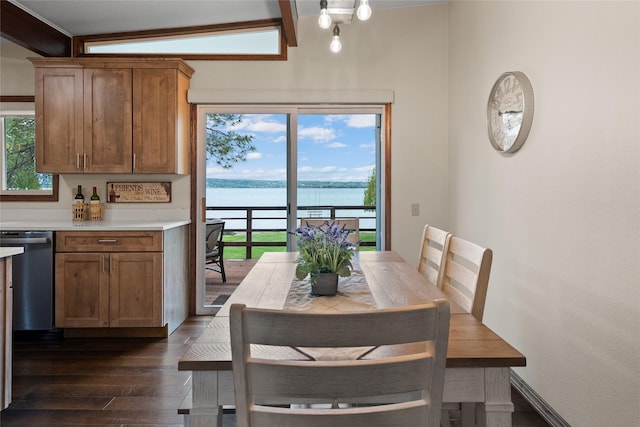 38941 Baypoint Ln, Polson, MT 59860 - dining area featuring dark wood-style flooring, a water view, and beam ceiling