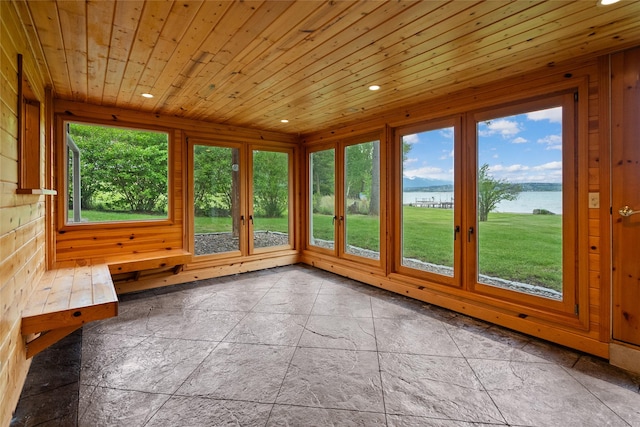 38941 Baypoint Ln, Polson, MT 59860 - unfurnished sunroom featuring a water view, french doors, recessed lighting, wood ceiling, and stone tile floors
