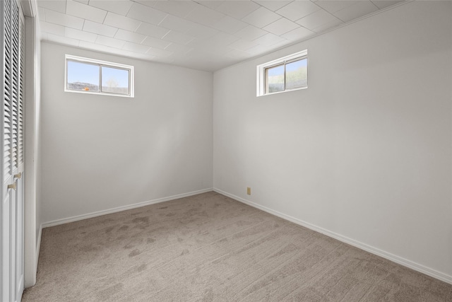 38941 Baypoint Ln, Polson, MT 59860 - below grade area featuring healthy amount of natural light, carpet flooring, and baseboards