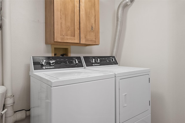 38941 Baypoint Ln, Polson, MT 59860 - washroom featuring cabinet space and washer and clothes dryer