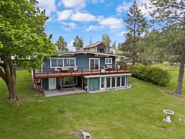 38941 Baypoint Ln, Polson, MT 59860 - back of property featuring a deck, a patio, and a yard