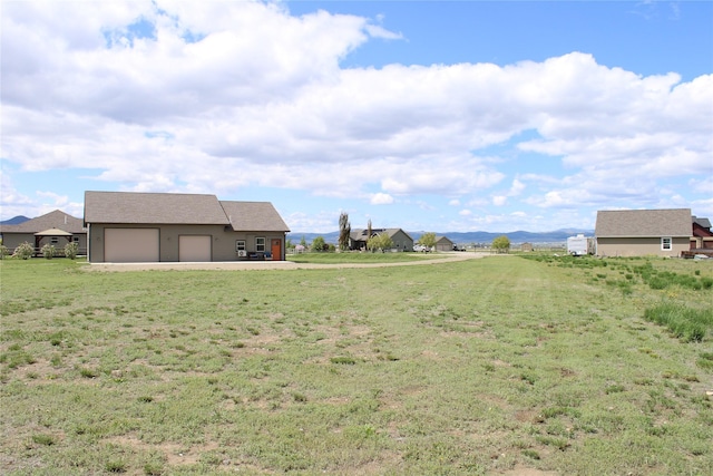 2567 Reardon Rd, Helena, MT 59602 - view of green lawn featuring an attached garage and driveway