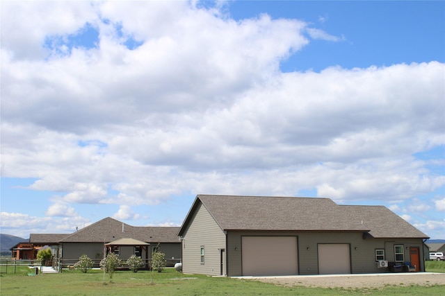 2567 Reardon Rd, Helena, MT 59602 - view of side of property with a gazebo, an attached garage, a shingled roof, and dirt driveway