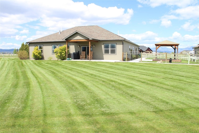 2567 Reardon Rd, Helena, MT 59602 - rear view of property featuring a gazebo, a patio, and a shingled roof