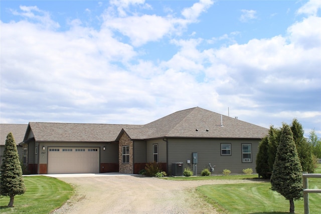 2567 Reardon Rd, Helena, MT 59602 - view of front of home featuring an attached garage, driveway, a front yard, central air condition unit, and roof with shingles