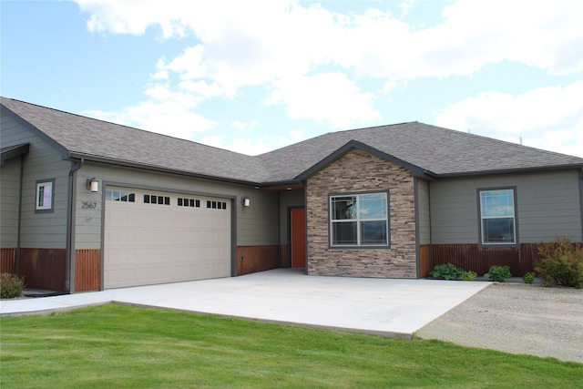 2567 Reardon Rd, Helena, MT 59602 - view of front of property featuring an attached garage, driveway, roof with shingles, and stone siding