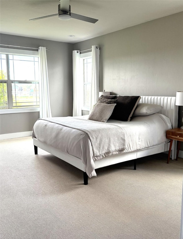 2567 Reardon Rd, Helena, MT 59602 - carpeted bedroom with multiple windows, a ceiling fan, and baseboards