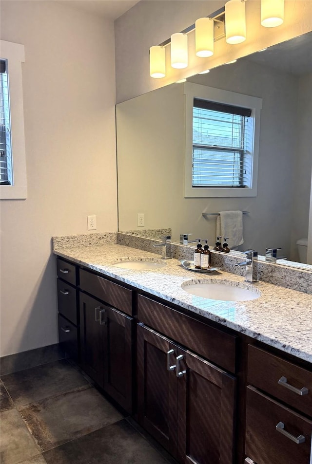 2567 Reardon Rd, Helena, MT 59602 - bathroom with double vanity, toilet, and baseboards