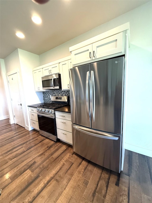 2567 Reardon Rd, Helena, MT 59602 - kitchen with stainless steel appliances, dark countertops, dark wood-style floors, white cabinetry, and recessed lighting
