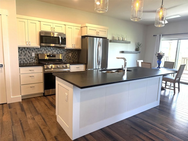 2567 Reardon Rd, Helena, MT 59602 - kitchen featuring stainless steel appliances, a sink, dark countertops, dark wood-style floors, and tasteful backsplash