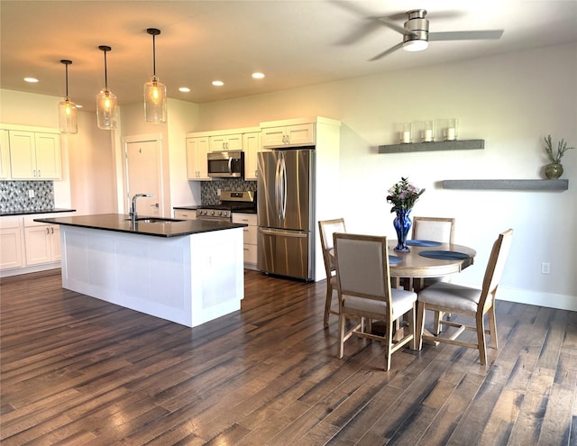 2567 Reardon Rd, Helena, MT 59602 - kitchen with appliances with stainless steel finishes, a sink, dark countertops, backsplash, and recessed lighting
