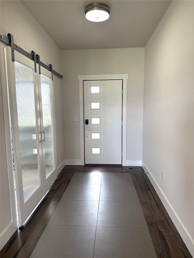 2567 Reardon Rd, Helena, MT 59602 - entryway featuring a barn door, baseboards, and dark wood finished floors