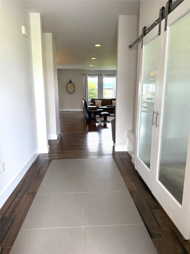 2567 Reardon Rd, Helena, MT 59602 - hallway featuring recessed lighting, tile patterned flooring, a barn door, and baseboards