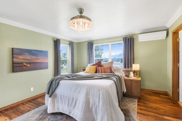 5634 Fairview Ln, Florence, MT 59833 - bedroom featuring a wall mounted AC, wood finished floors, a chandelier, crown molding, and baseboards