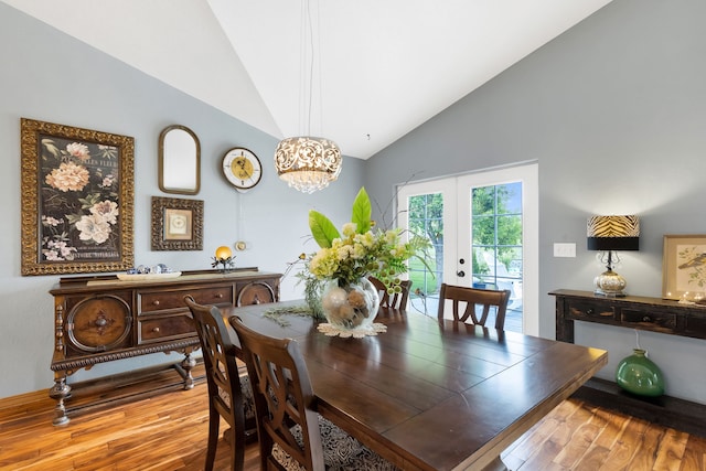 5634 Fairview Ln, Florence, MT 59833 - dining room with wood finished floors, french doors, high vaulted ceiling, and a chandelier