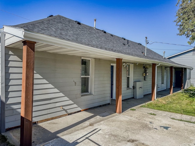 211 W Main St, East Helena, MT 59635 - back of house with a shingled roof and a patio area