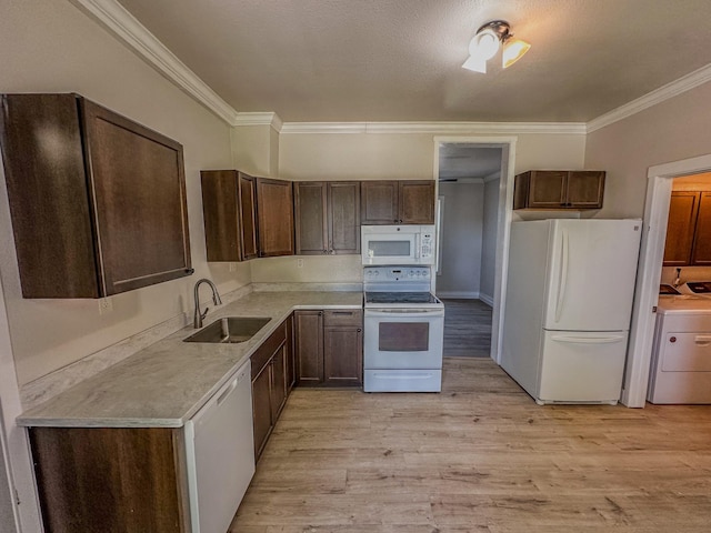 211 W Main St, East Helena, MT 59635 - kitchen featuring white appliances, washer / dryer, a sink, crown molding, and dark brown cabinets