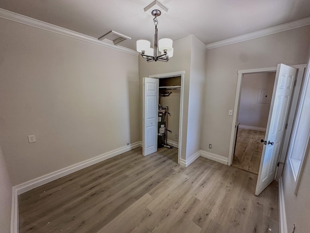 211 W Main St, East Helena, MT 59635 - unfurnished dining area featuring ornamental molding, light wood finished floors, a chandelier, and baseboards