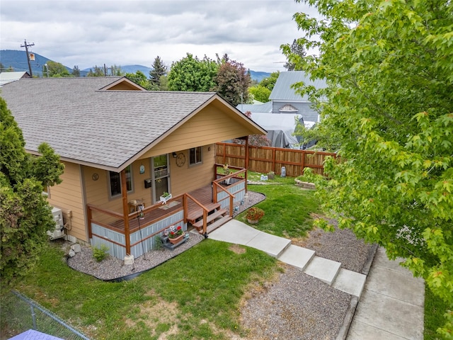 1118 Dakota Ave, Libby, MT 59923 - view of front of property featuring roof with shingles and a deck with mountain view