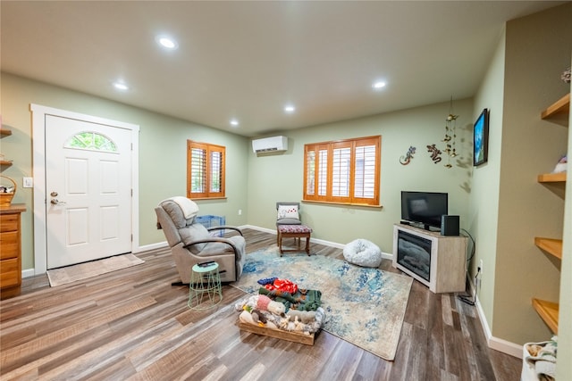 1118 Dakota Ave, Libby, MT 59923 - living area featuring a wall unit AC, wood finished floors, recessed lighting, and baseboards