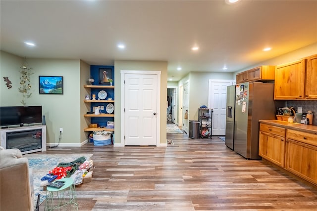 1118 Dakota Ave, Libby, MT 59923 - kitchen with stainless steel fridge with ice dispenser, light wood-type flooring, recessed lighting, baseboards, and tasteful backsplash