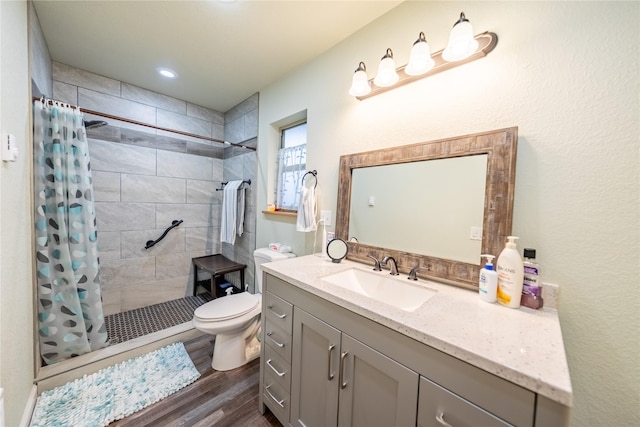 1118 Dakota Ave, Libby, MT 59923 - full bathroom featuring wood finished floors, toilet, tiled shower, and vanity