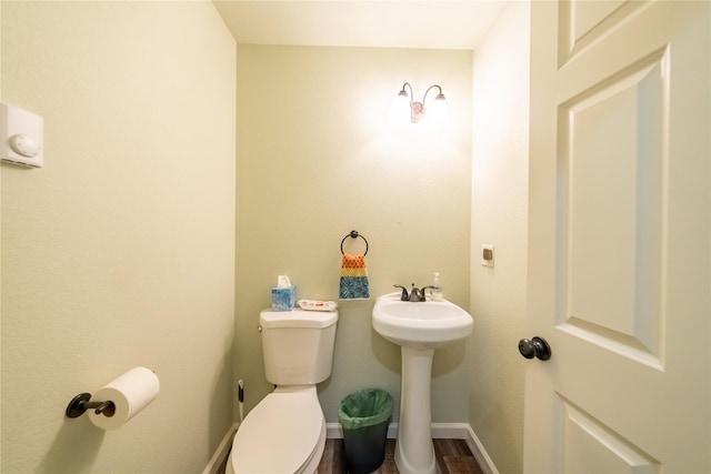 1118 Dakota Ave, Libby, MT 59923 - half bath with toilet, baseboards, and a sink