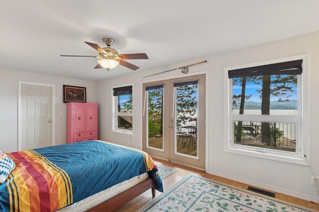 33604 Whitecap Ln, Bigfork, MT 59911 - bedroom with access to outside, light wood-type flooring, baseboards, and a ceiling fan