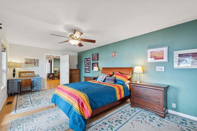 33604 Whitecap Ln, Bigfork, MT 59911 - bedroom featuring wood finished floors, a ceiling fan, and baseboards