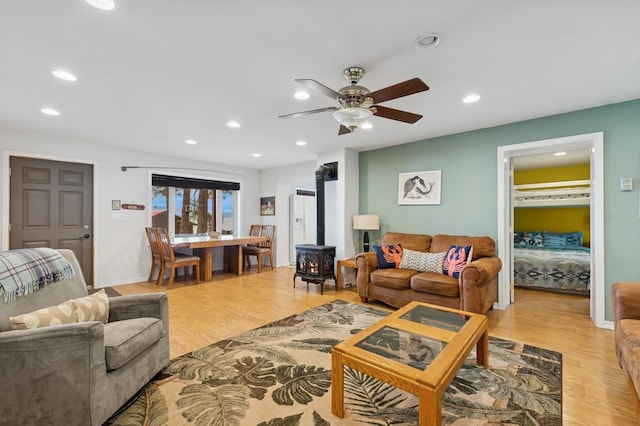 33604 Whitecap Ln, Bigfork, MT 59911 - living area featuring a wood stove, light wood-type flooring, recessed lighting, and a ceiling fan
