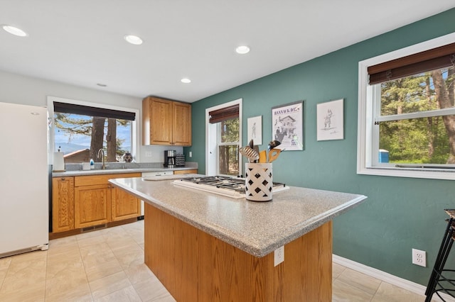 33604 Whitecap Ln, Bigfork, MT 59911 - kitchen featuring freestanding refrigerator, healthy amount of natural light, a center island, light countertops, and recessed lighting