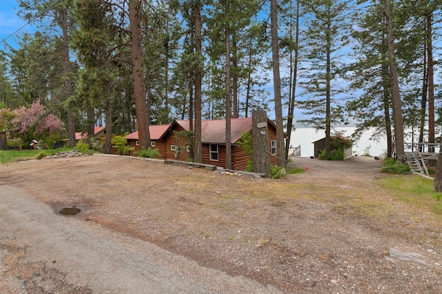 33604 Whitecap Ln, Bigfork, MT 59911 - cabin with driveway and metal roof