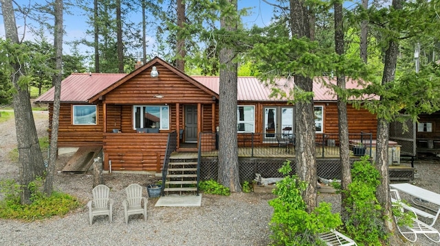 33604 Whitecap Ln, Bigfork, MT 59911 - view of front facade featuring metal roof and a deck